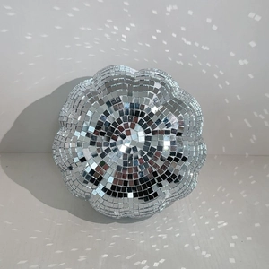 Detailed view of pumpkin disco ball with silver glass mirrors reflecting sparkling light