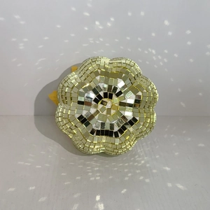 Detailed view of pumpkin-shaped disco ball with floral mosaic mirror tiles and light spots