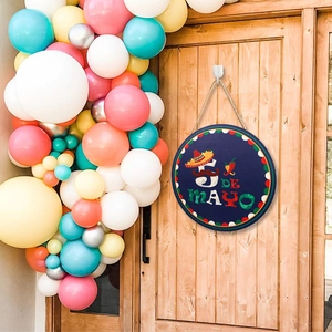 Cinco de Mayo door sign with sombrero and chili icons hanging on a wooden door