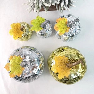 Detail of five-piece disco mirror pumpkin set with gold and silver mosaic tiles and maple leaves