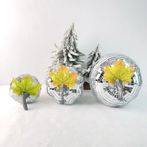 Three disco mirror pumpkin ornaments with silver sequins and maple leaf details