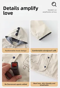 Detail view of toddler beige dinosaur hoodie with check lining and windproof cuffs