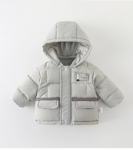 Detail of grey hooded puffer jacket with horizontal quilting and woven waist strap