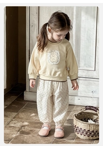 Close-up of baby girl cotton sweater featuring a cute bunny patch and floral polka dot pants