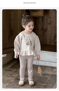 Detail of baby girl beige sweatshirt with cat print and ribbed leggings set for autumn