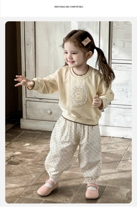 Detail view of baby girl long sleeve sweatshirt and polka dot pants set with rabbit patch