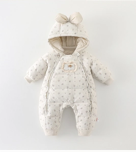 Detail of white floral baby down puffer romper with hood bow and lace badge