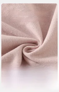 Close-up of soft pink ribbed knit fabric detail showing premium cotton texture