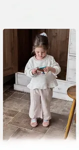 Detail view of toddler girls ruffle sweatshirt with rabbit print and pink flared pants