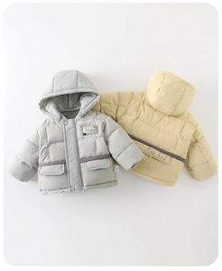 Detailed view of quilted winter jackets for babies featuring hoods and flap pockets