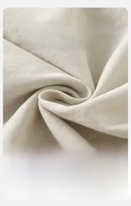 Detailed macro view of soft breathable cream knit fabric for baby clothing sets