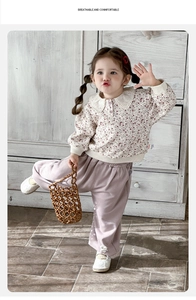 Detail of floral sweatshirt with lace Peter Pan collar and purple cotton pants for girls