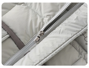 Macro view of zipper system and quilted fabric on light grey winter down jacket