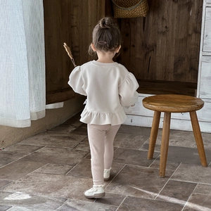 Toddler girl beige sweatshirt with ruffles and pink ribbed pants two-piece outfit