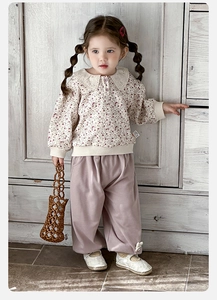 Detail of floral sweatshirt with lace collar and matching wide-leg pants for girls