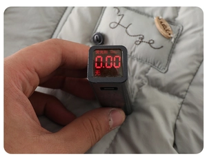 Fluorescence test showing 0.00mg/l on quilted winter jacket fabric with a digital detector