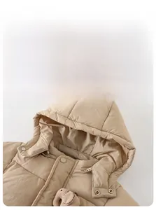 Detailed view of winter baby hooded down jacket with cute elephant plush accessory