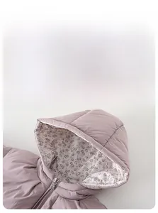 Detail of pink toddler down jacket showing floral lining and smooth metal zipper puller