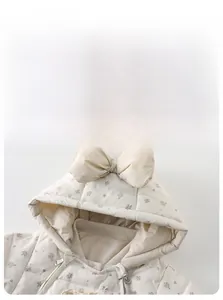 Detailed view of baby floral hooded puffer suit with cute bow and quilted fabric