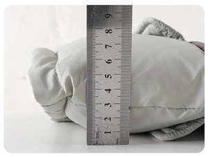 Detail shot of winter down jacket thickness measuring approximately 8cm for insulation