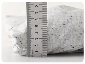 Close-up showing 8cm thickness measurement of the warm padded infant jacket with a ruler