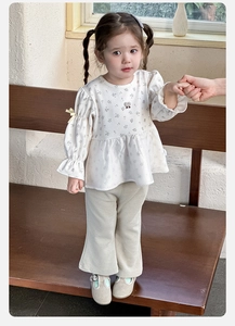 Detail of baby girl floral puff sleeve blouse with cherry embroidery and flared pants