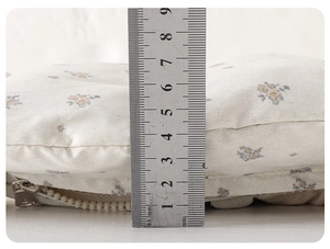 Close-up of baby winter jumpsuit fabric showing floral pattern and 9cm thickness