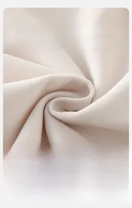 Macro shot of soft cream knit fabric texture for baby shirt showing breathable weave