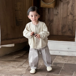 Three-piece baby spring set with cream button jacket and loose cotton trousers in soft tones