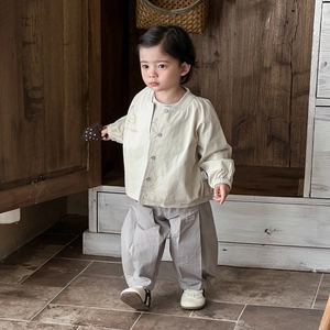 Spring baby clothing set featuring cream button-up jacket and grey relaxed casual trousers