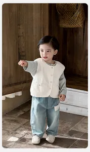 Three-piece baby boy outfit featuring cream vest, grey sleeve top and washed denim pants