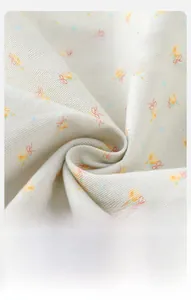 Macro shot of soft cream fabric with yellow floral print and rib knit texture