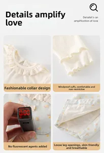 Close-up of cotton floral baby outfit with ruffle collar and snap button details