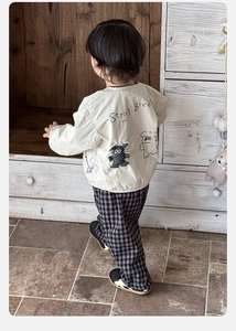 Detail view of toddler beige jacket back with Stray Bird embroidery and plaid pants