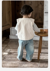 Detail view of toddler vest and denim set shown from behind on a child model