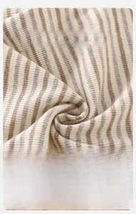 Close-up of soft brown striped knit fabric for baby clothes with breathable texture