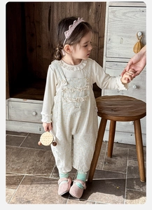 Detail view of cotton floral overalls and ruffle collar shirt for baby girls outfit