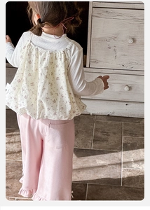 Detail view of toddler floral three-piece set with ruffled pants and polka dot shirt