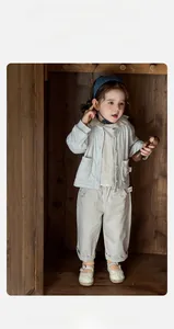 Detail view of toddler girl casual cotton set with grey jacket and embroidered trousers