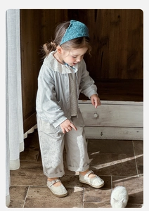 Detail of 3-piece toddler girl outfit with knit cardigan, floral collar shirt and pants