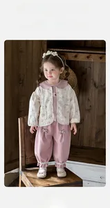 Detailed look at toddler floral cardigan, pink top and bloomers set with bow accents