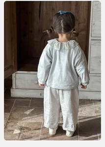 Detail of toddler girl set featuring floral Peter Pan collar and ribbed knit texture