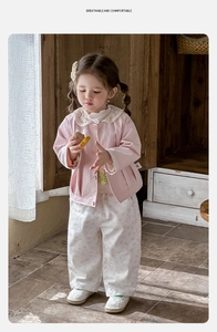 Détail veste rose en coton avec col en dentelle et pantalon fleuri pour bébé fille printemps