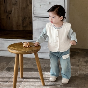 Three-piece baby boy outfit with beige vest, green shirt, and light blue denim pants