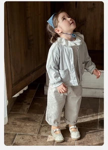 Detailed close-up of light blue waffle texture fabric on toddler cardigan and pants set