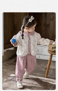 Detail of floral baby jacket and pink bloomers with ruffles and bow accents
