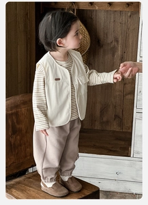 Three-piece boys vintage outfit with beige corduroy vest, striped tee, and joggers