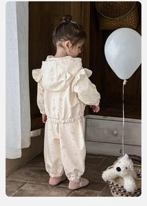 Dettaglio di completo con felpa e pantaloni per bambina con orecchie e stampe di orsi