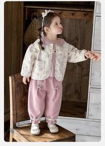 Detail of baby girl floral quilted cardigan and purple bloomers with lace trim