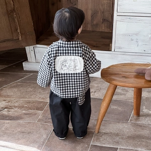Baby boy spring outfit featuring a plaid shirt with back graphic and black trousers